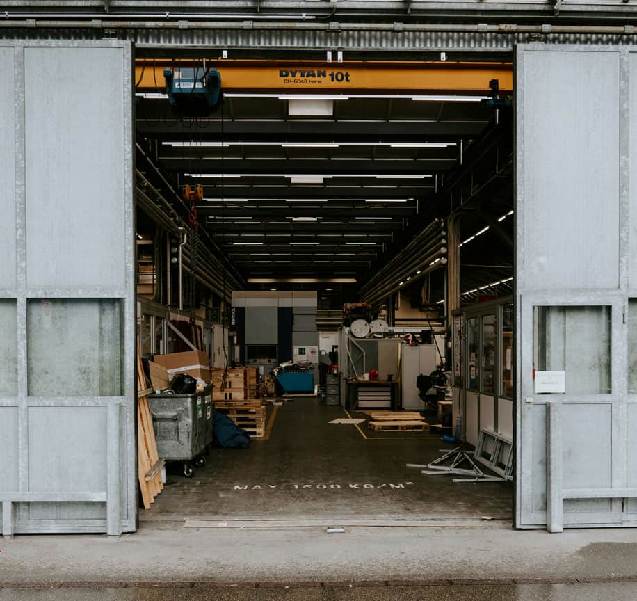 Warehouse interior with cleaning equipment and storage shelves for cleaning services.