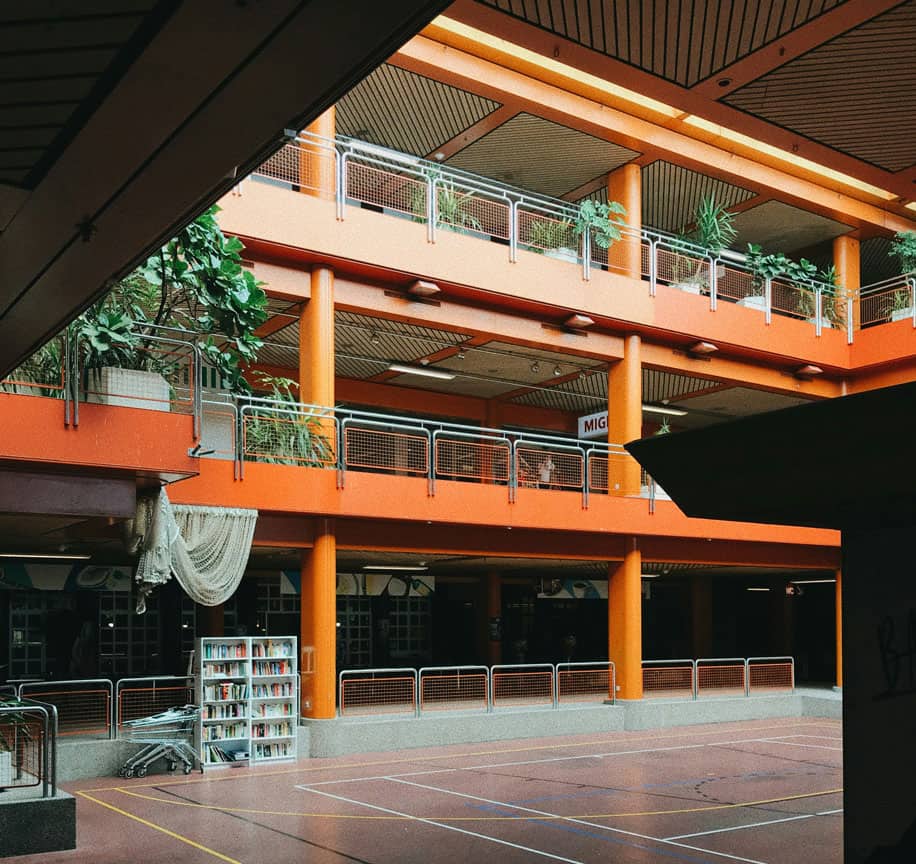 Modern sports centre with clean floors and well-maintained balconies.